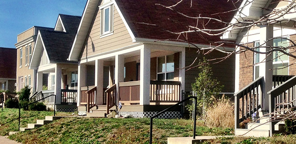 Four Habitat for Humanity houses, showing front lawns with paths.